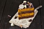 Slice Of Chocolate And Toffee Layer Cake Stock Photo