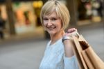 Middle Aged Woman Holding Shopping Bags Stock Photo