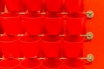 Red Plastic Cup Display On Wall Stock Photo