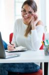 Pretty Young Woman Working In Her Office Stock Photo