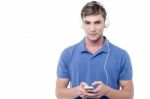 Young Man Enjoying Music And Using His Mobile Stock Photo