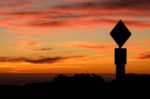 Road Sign Silhouette And Colorful Sunset Stock Photo