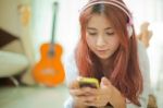 Young Asian Woman Listening To Music Stock Photo