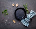 Empty Old Cast Iron Skille On Dark Stone Background. Ingredients Stock Photo