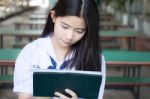 Portrait Of Thai Student Teen Beautiful Girl Using Her Tablet Stock Photo