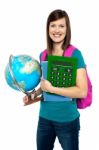 Smiling Female Student Holding A Calculator And Globe Stock Photo