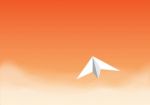 Paper Plane Flying In The Orange Sky Stock Photo