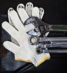 Wrenches Spanners Plumbing And Mechanic Glove On Dark Metal Back Stock Photo