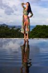 Pretty Brunette Model In Bikini Posing At The Pool Stock Photo