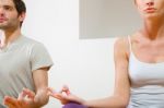 Couple Sitting On Floor Doing Yoga Stock Photo