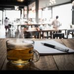 Hot Tea With Notebook And Pen On Wooden Table Stock Photo