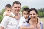 Beautiful Couple Carrying Their Kids On Their Back Stock Photo