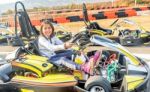 Little Girl Is Driving Go- Kart Car In A Playground Racing Track Stock Photo