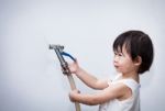 Little Asian Girl Play With Water Hose Stock Photo