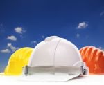 Three Of Safety Helmet Construction Protection On White Against Stock Photo