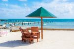 Umbrella And Chairs On The Beach In Caye Caulker, Belize Stock Photo