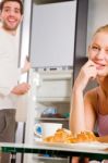 Couple In Kitchen Having Breakfast Stock Photo