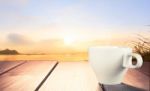 Morning Cup Of Coffee With River Background At Sunrise Stock Photo