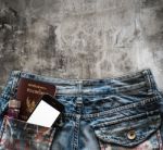 Blue Jeans With Cell Phone, Flashlight And Passport In A Pocket Stock Photo