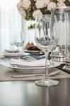 Empty Wine Glass On Wooden Dinning Table With Table Set Stock Photo