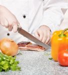 Chef Cutting Bacon Stock Photo