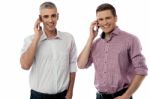 Smiling Young Men With Cell Phones Stock Photo