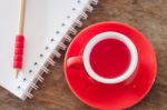 Red Mug With Open Notebook Stock Photo