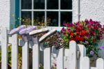 Two Pairs Of Boots Placed On Fence Posts Stock Photo