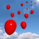 Red Balloons flying In The Sky Stock Photo