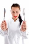 Female Chef holding Fork And Knife Stock Photo