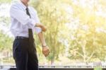 A Young Businessman Is Folding A White Sleeve On His Balcony Stock Photo