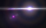 Abstract Thick Lens Flare Light Over Black Background Stock Photo