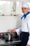 Male Cook Prepares A Dish In The Kitchen Stock Photo