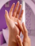 Putting Moisturizer On Hands Stock Photo