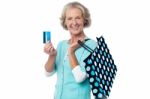 Aged Woman Displaying Her Cash Card Stock Photo