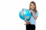 Smart Young Girl Showing Her Country On A Globe Stock Photo