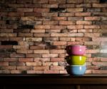 Colorful Tiffin Carrier On Wooden Cupboard Stock Photo