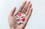 Top View Of The Pills On The Hand And White Background, A Hand Hold The Pills And Drug Stock Photo