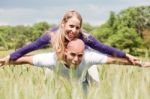 Teenage Couple With The Lady Piggybacking On Handsome Young Man Stock Photo