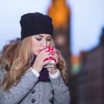 Attractive Young Stylish Blonde Girl Drinks Hot Drink From A Mug Stock Photo