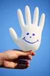 Hand Holding Smiling Glove With Blue Sky Stock Photo