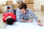 Young Couple Looking At The Blueprints Of Their New Home Stock Photo