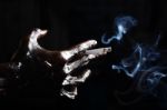 Dirty Hand With Cigarette Isolated On Black Background Stock Photo