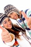 Cute Couple Wearing Warm Cap Showing Thumbs Up Stock Photo