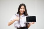 Portrait Of Thai High School Student Uniform Beautiful Girl Using Her Tablet Stock Photo