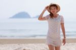 Woman In Hat On Beach Stock Photo