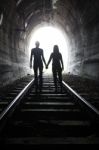 Couple Walking Together Through A Railway Tunnel Stock Photo