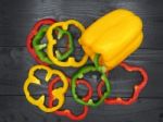 Fresh Vegetables, Red, Yellow, Green Sweet Peppers On Dark Wood Stock Photo