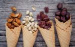 Concept For Homemade Various Nuts Ice Cream. Mixed Nuts In Waffl Stock Photo