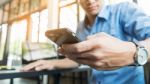 Smiling Young Casual Business Man With Mobile Phone In The Hand Stock Photo